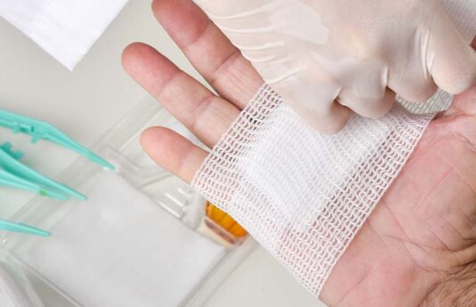 Doctor bandaging hand