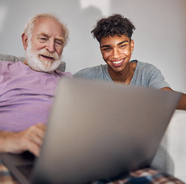 Grandfather & grandson using a laptop