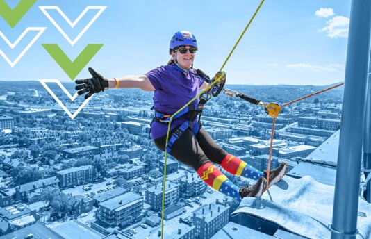 Christine rappelling over the edge