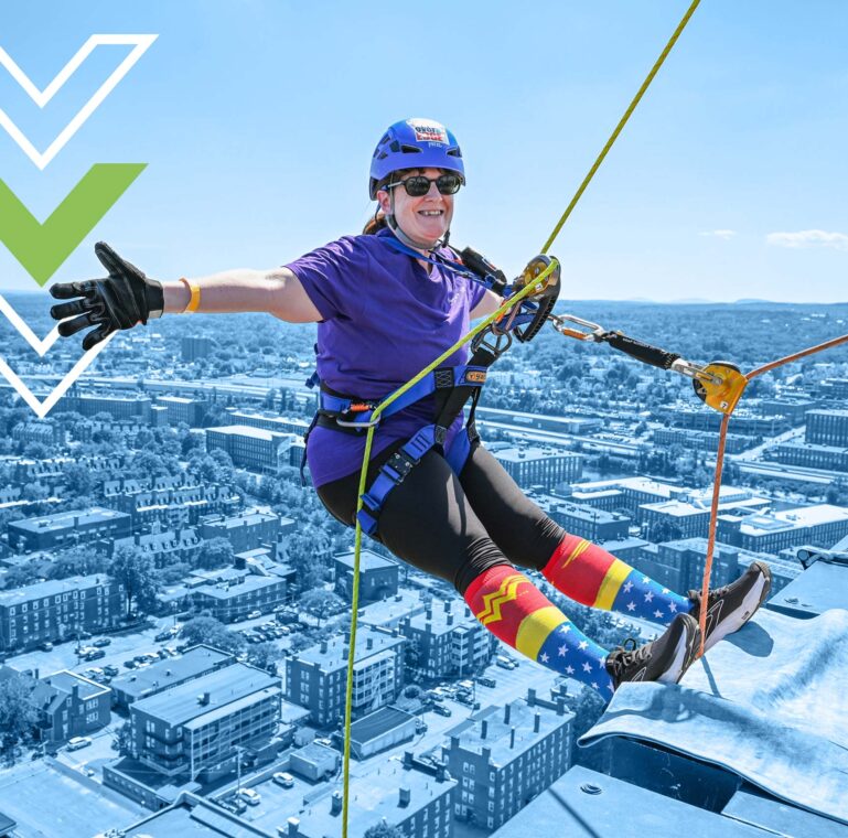 Christine rappelling over the edge